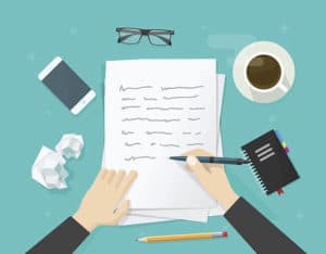 writer writing on paper