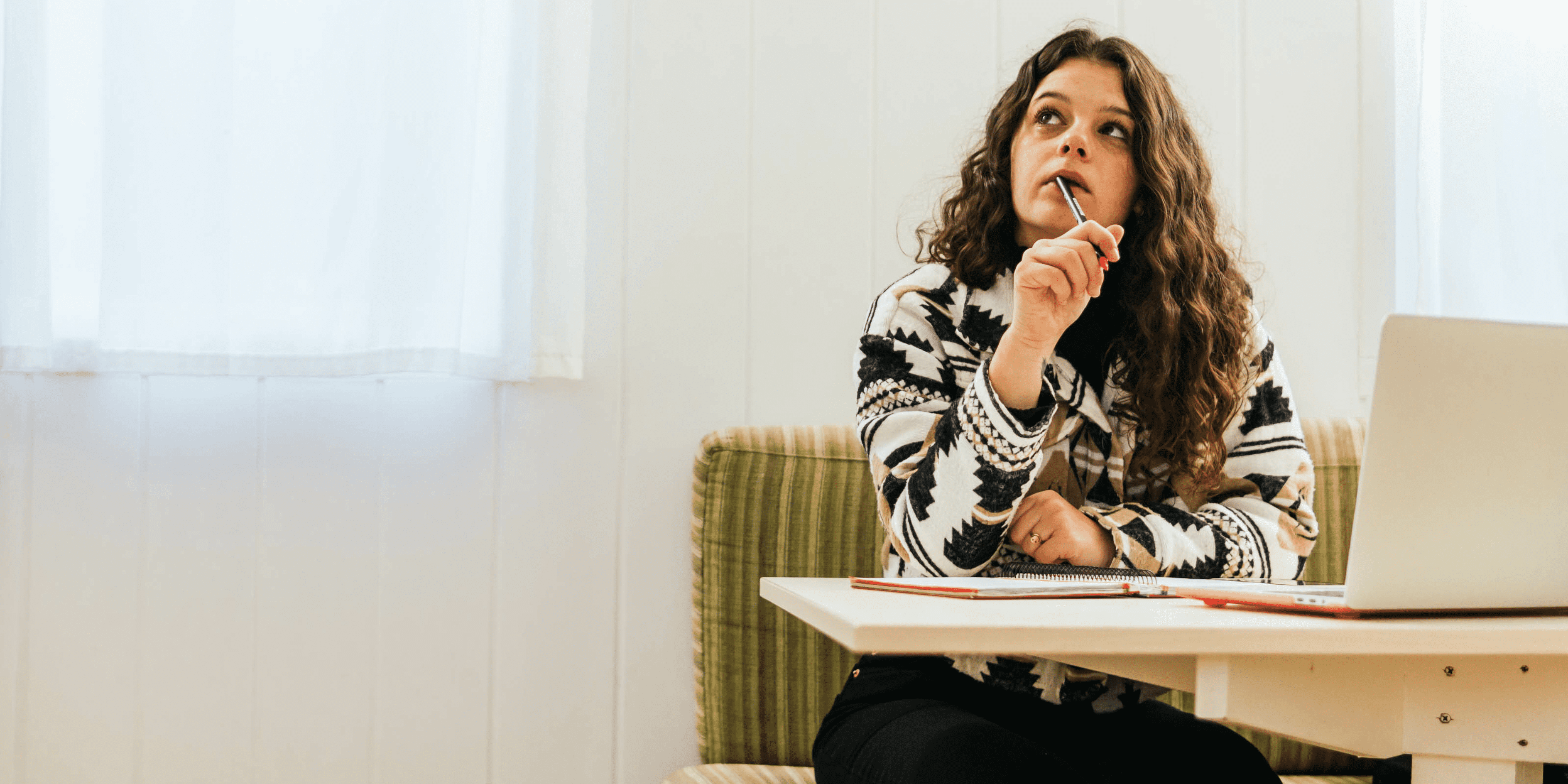 woman thinking while sitting at desk