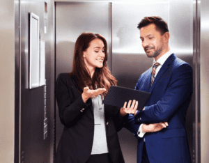 Picture of one business person giving an elevator pitch to another