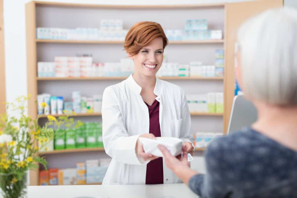 Major pharmaceutical employee handing over prescription