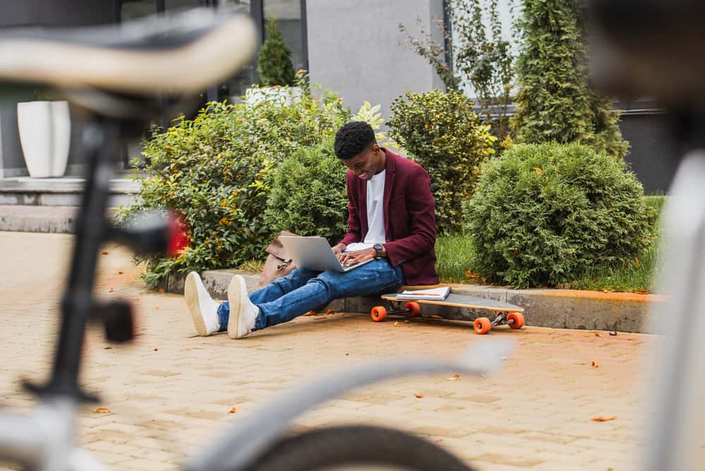 Student studying on their laptop outside