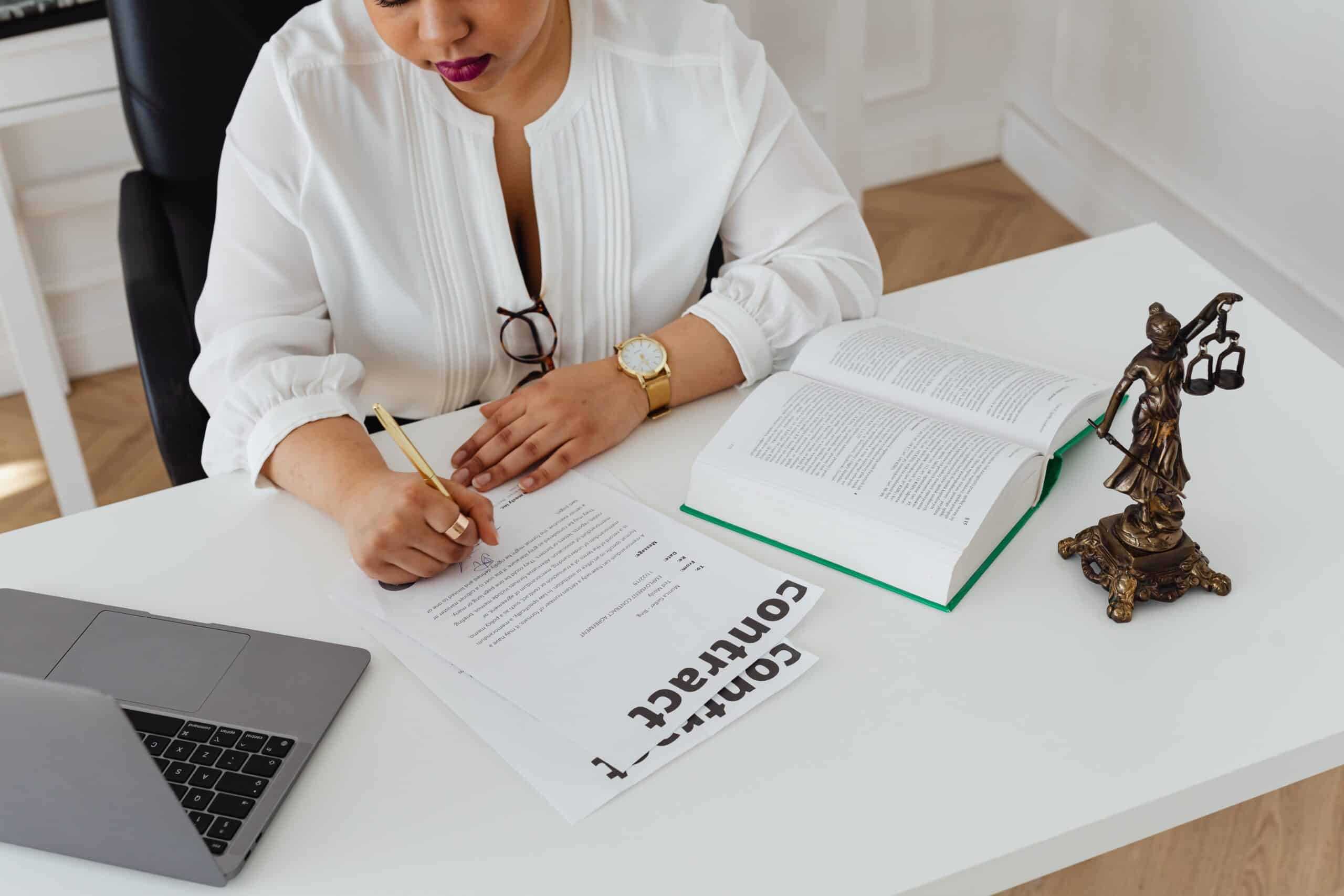 woman writing on civil rights law contract