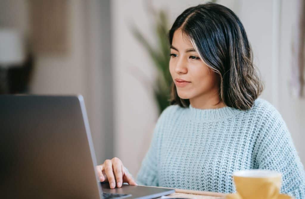 woman looking at fringe benefits on laptop