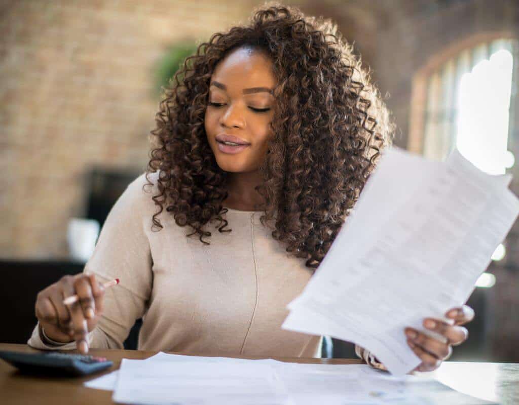 Woman checking finances, calculating the quick ratio.