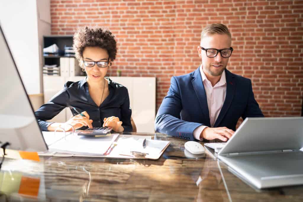 Accountants reviewing finances to create cash flow statement and other financial statements.