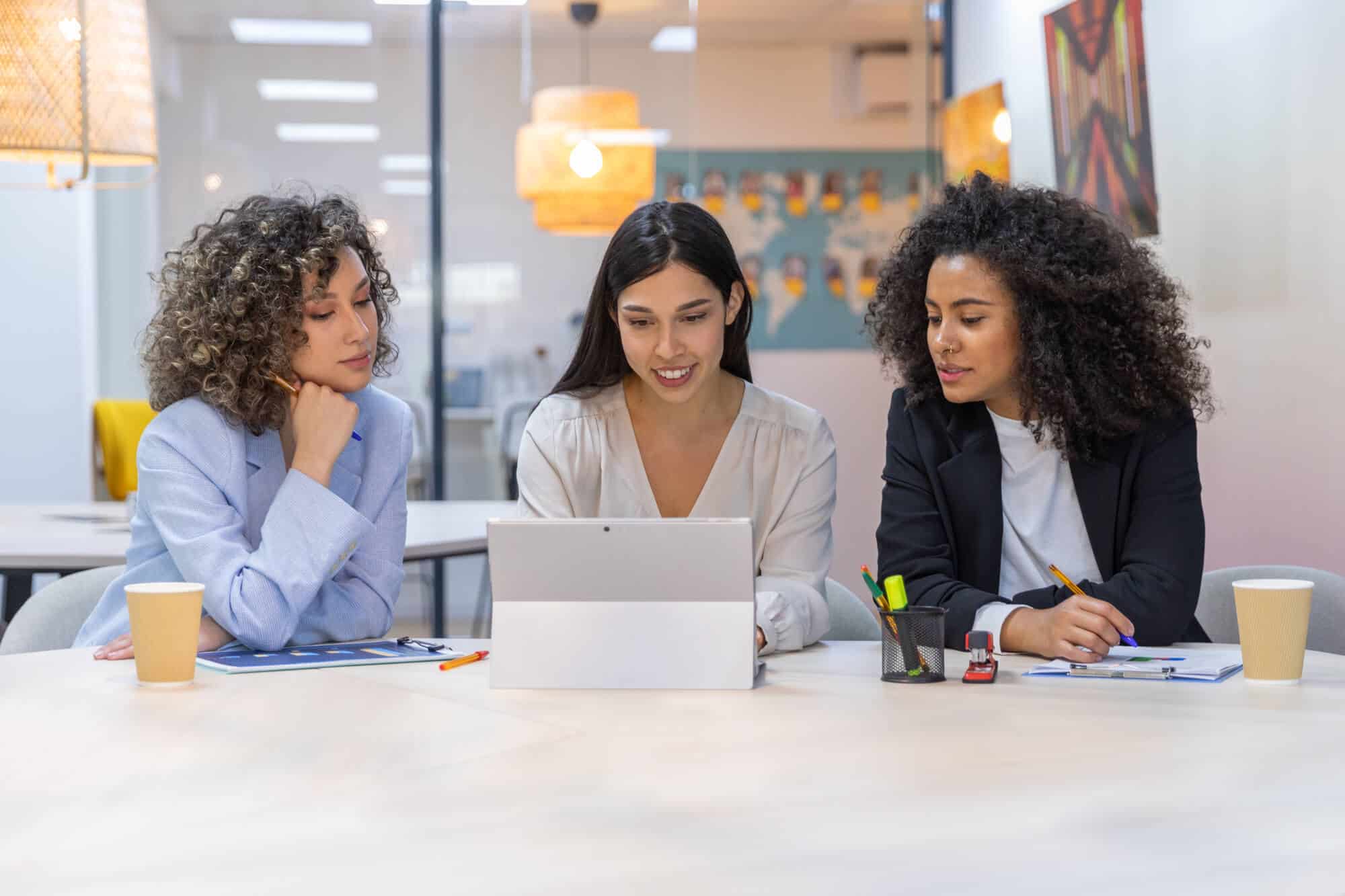 Businesswomen collaborate on a project at the office