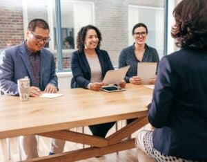 A picture of a woman in a panel interview