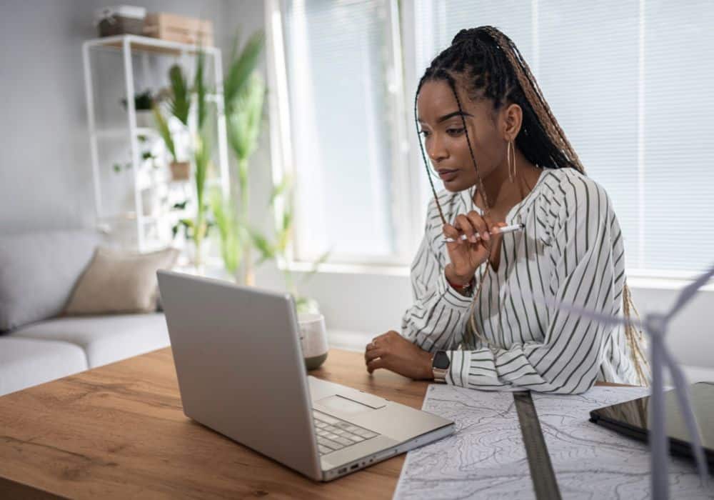 Person sitting at table looking at laptop