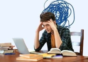 person sitting at desk with head down